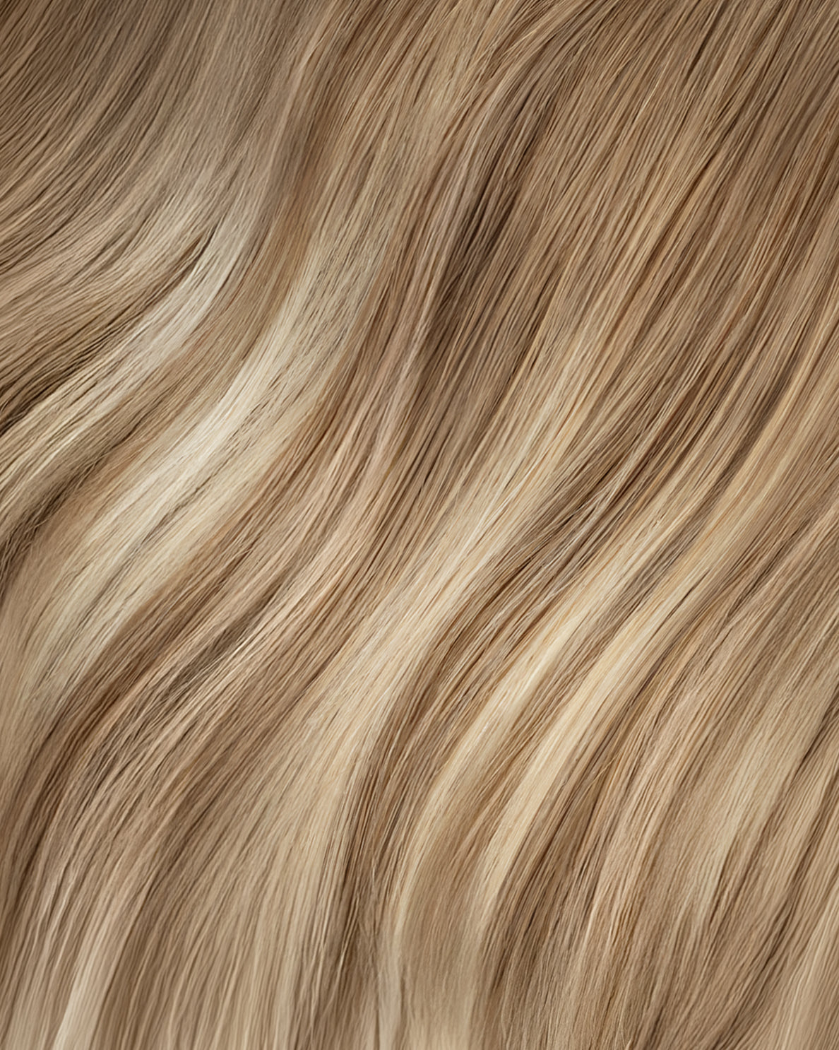 tape-in hair extensions rooted blonde highlights.