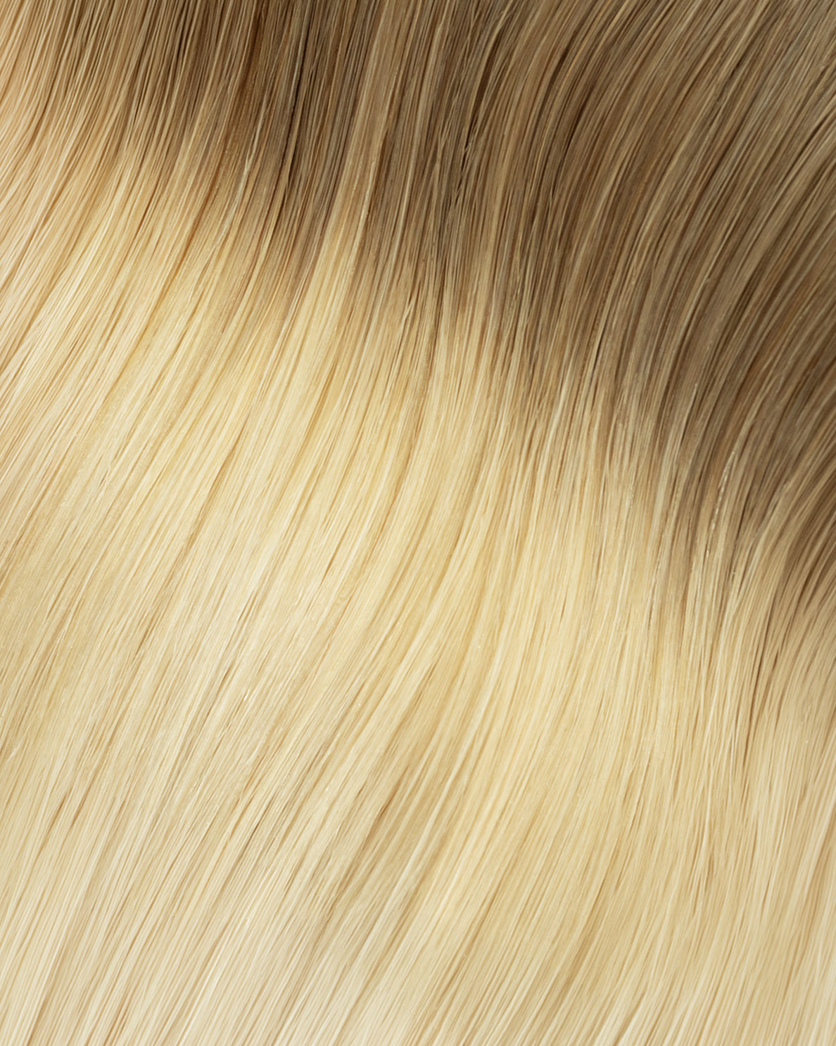 invisible clip-in hair extensions rooted blonde.