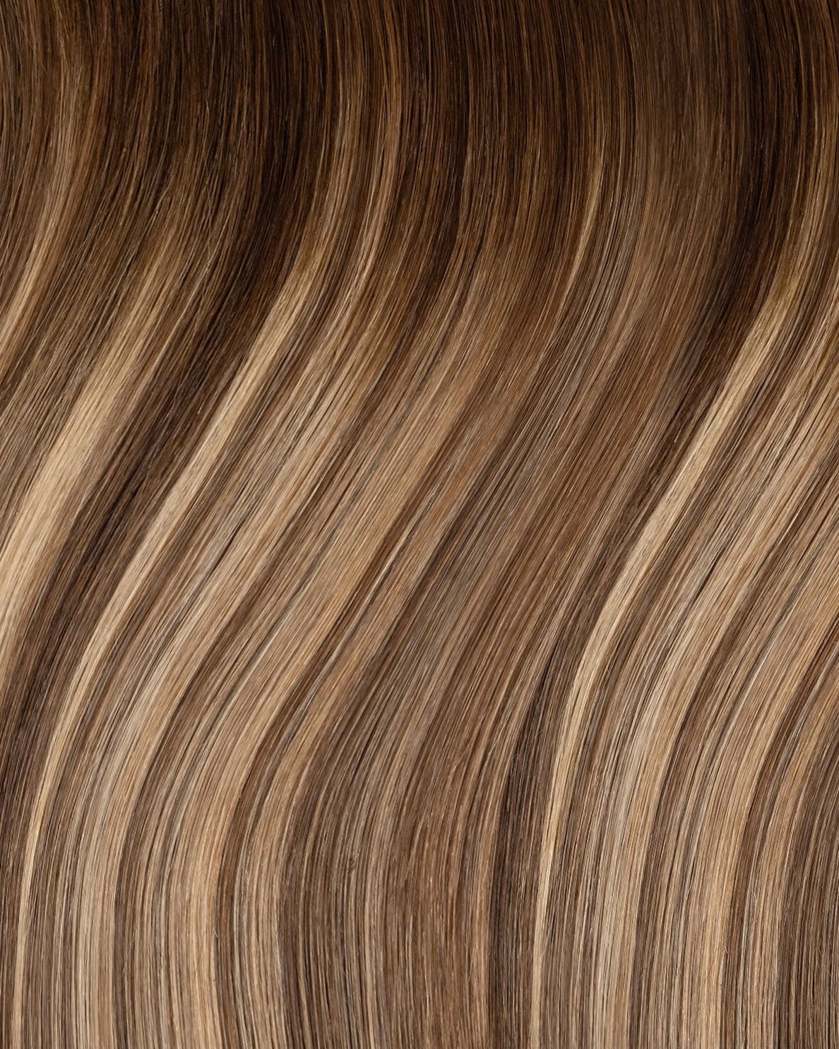 clip-in hair extensions rooted beige highlights.