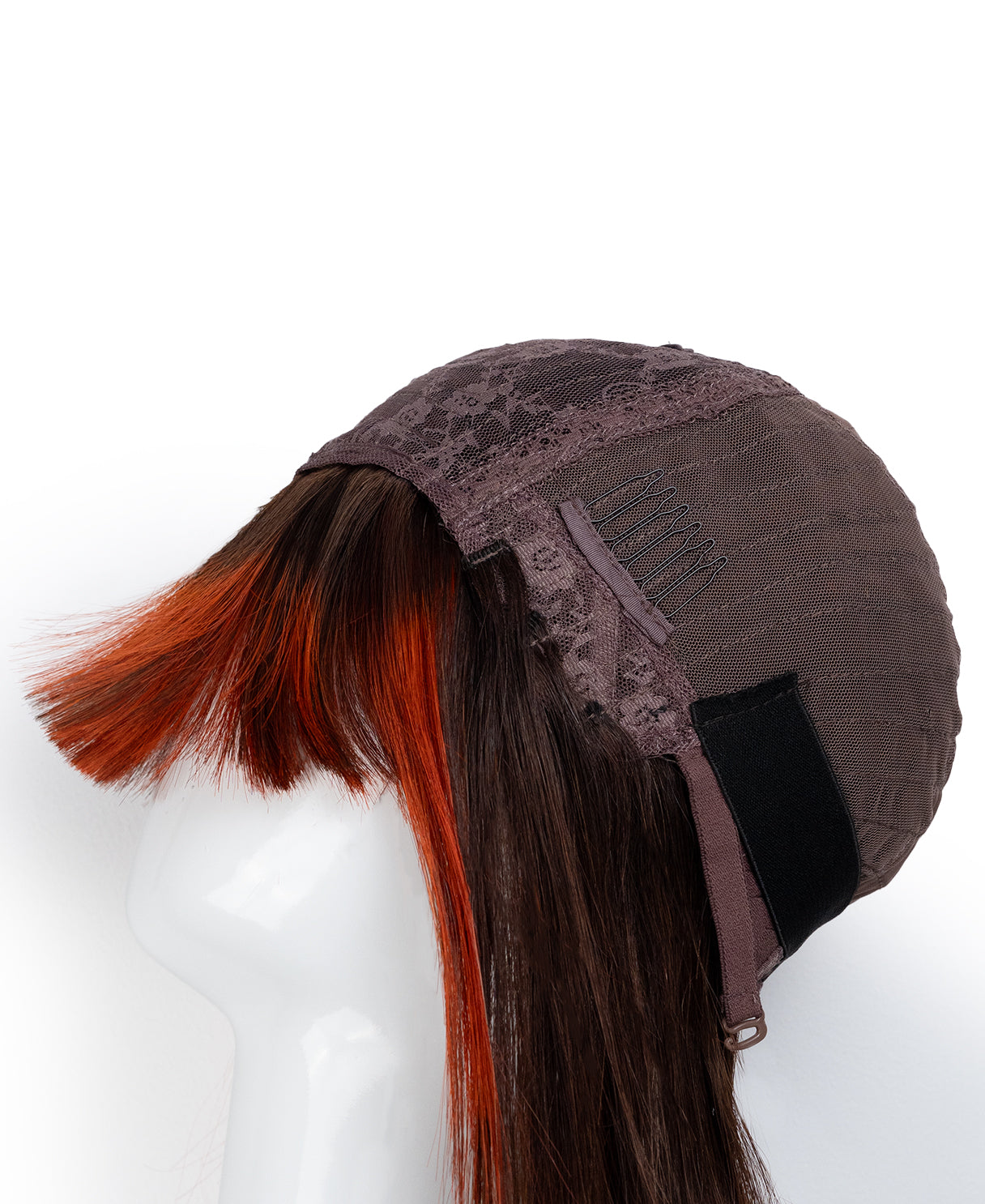 Brown wig cap with red hair extensions on a white background