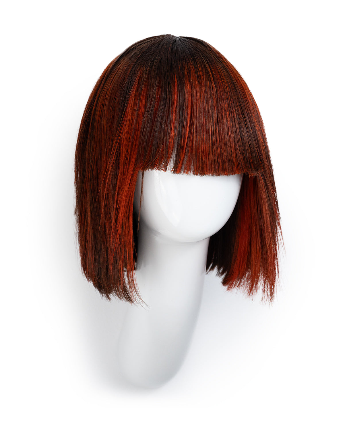 Red and black wig on a white mannequin head against a white background