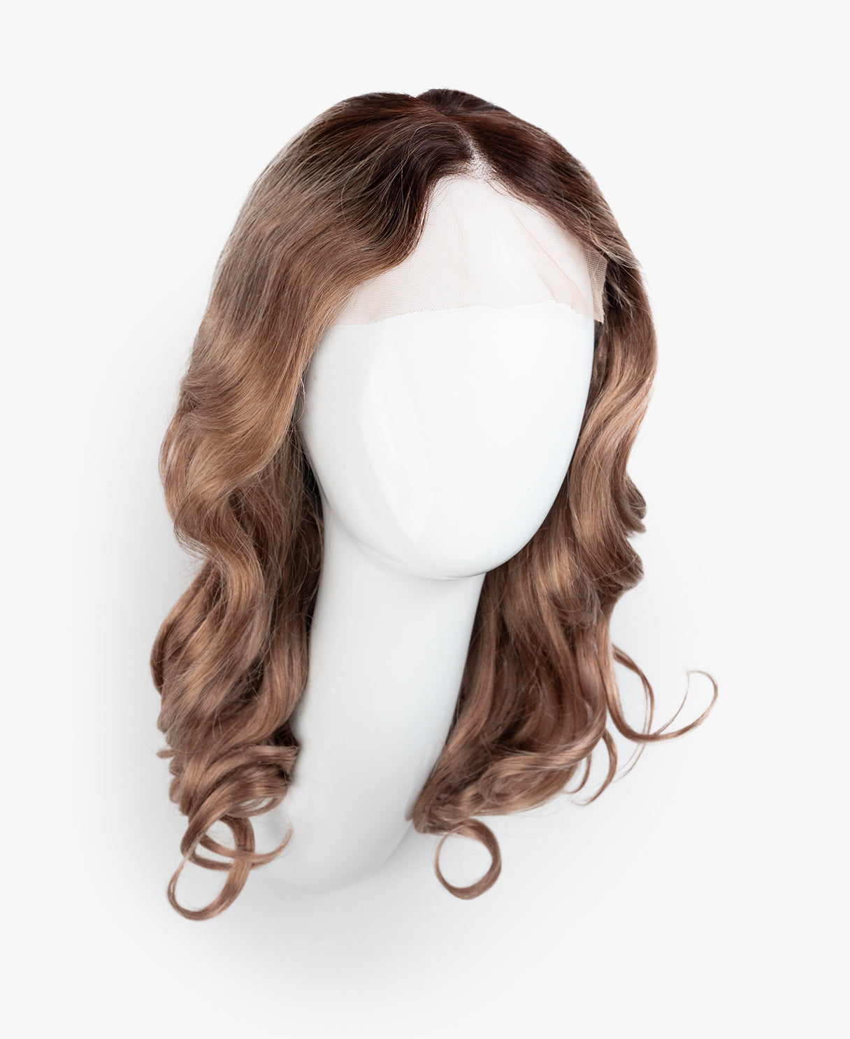 Brown wig on a mannequin head against a white background