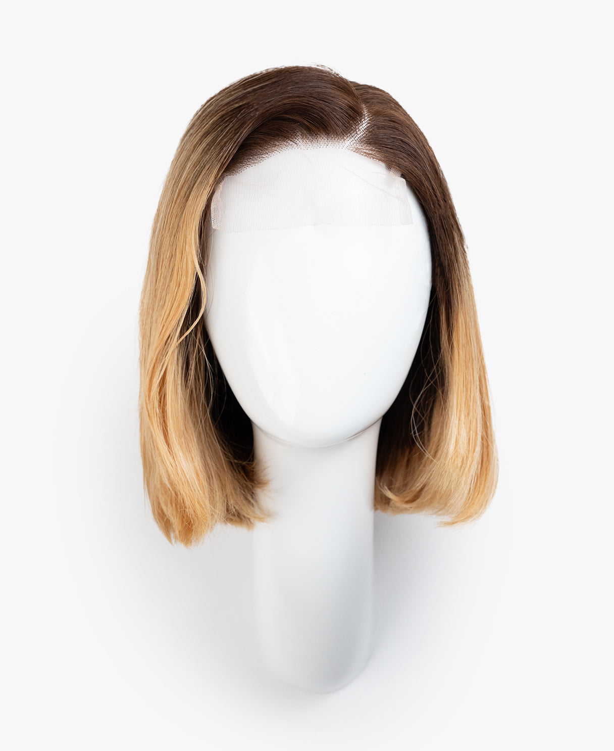 Blonde wig on a mannequin head against a white background