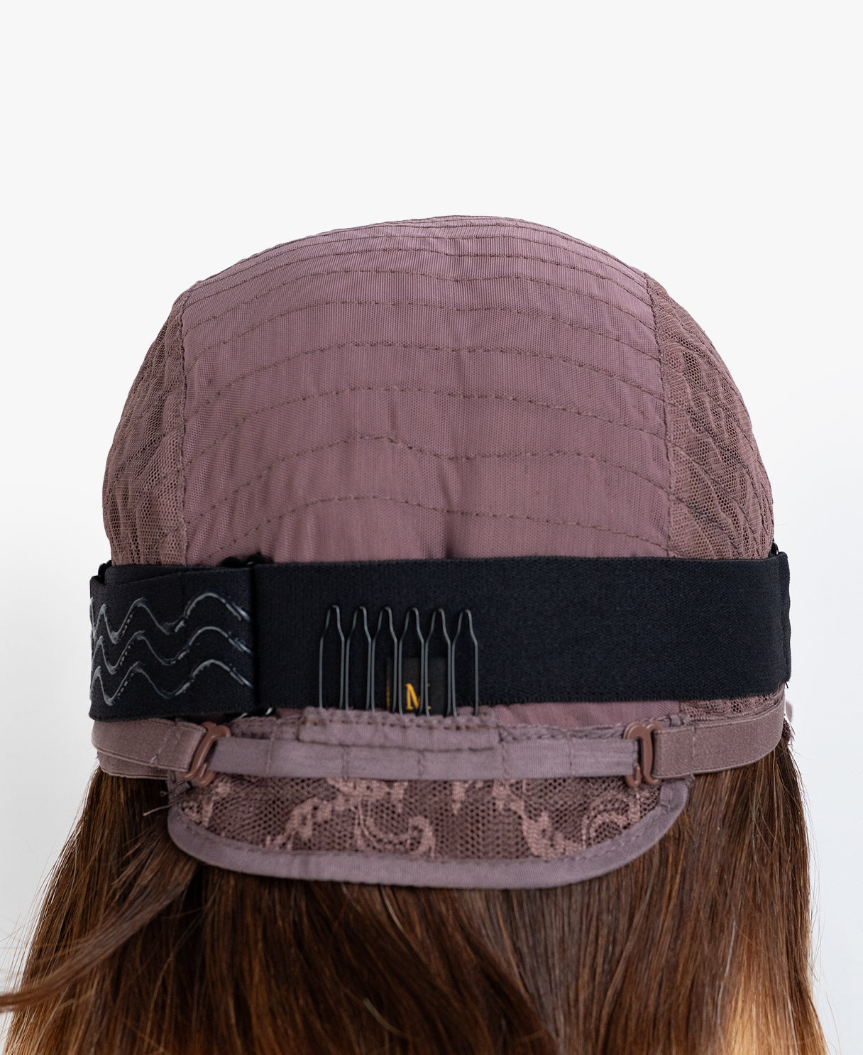 Brown wig cap with a black hairnet on a white background