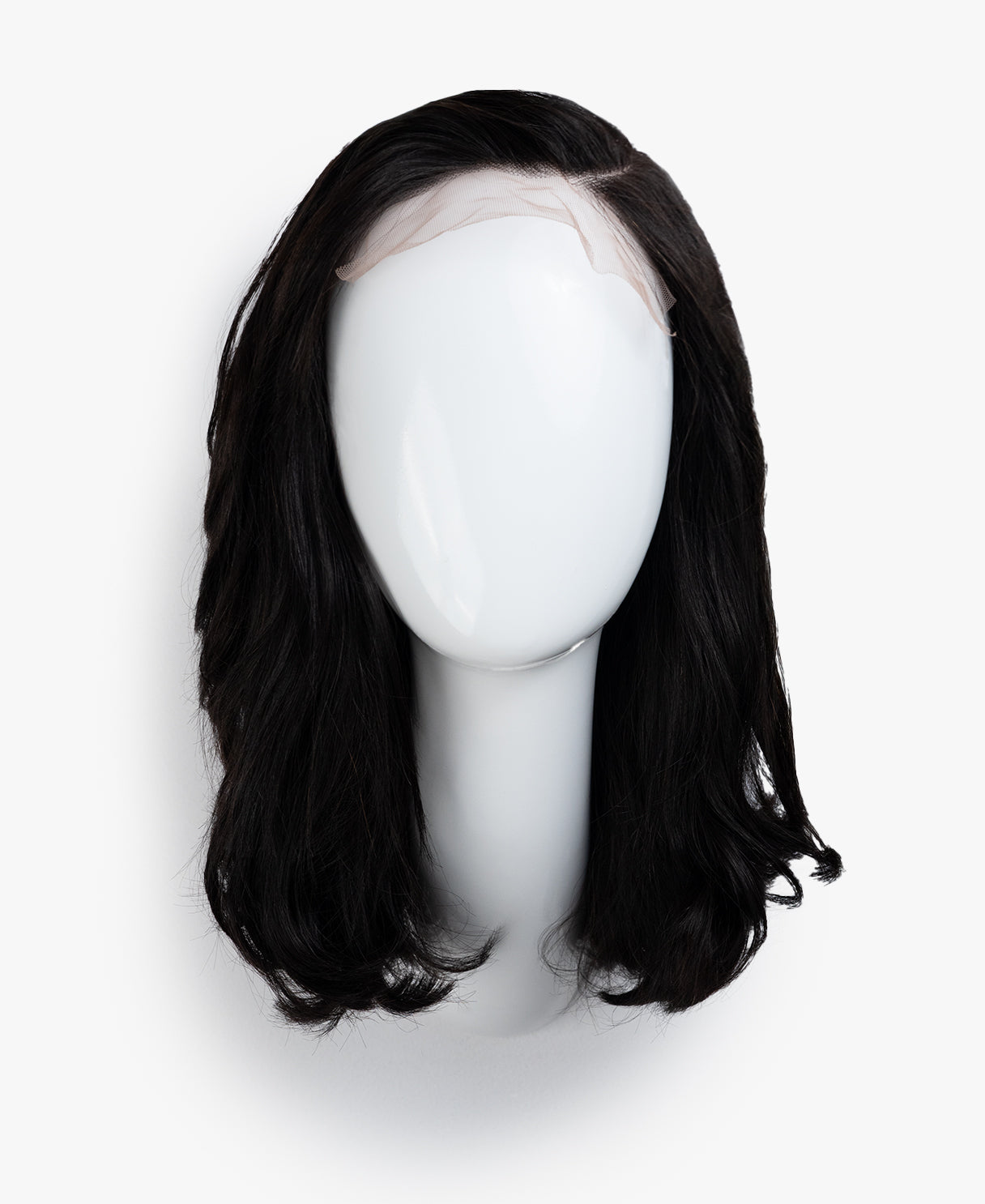 Black wig on a mannequin head against a white background