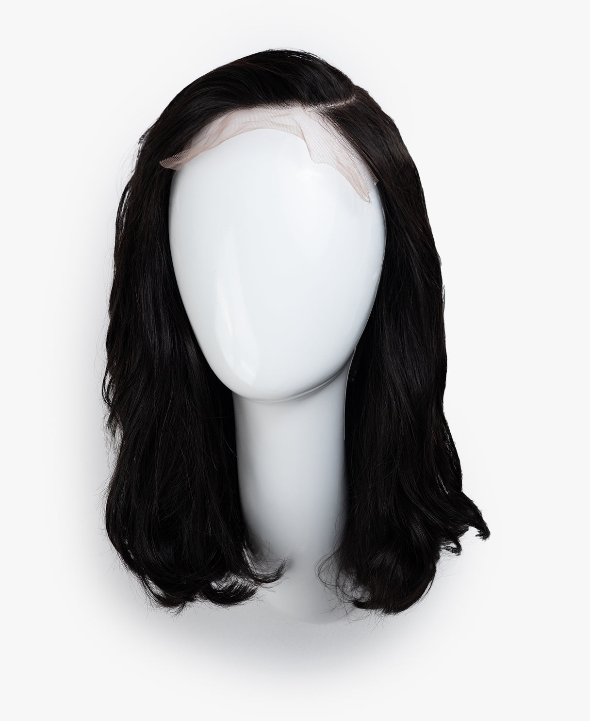 Black wig on a mannequin head against a white background