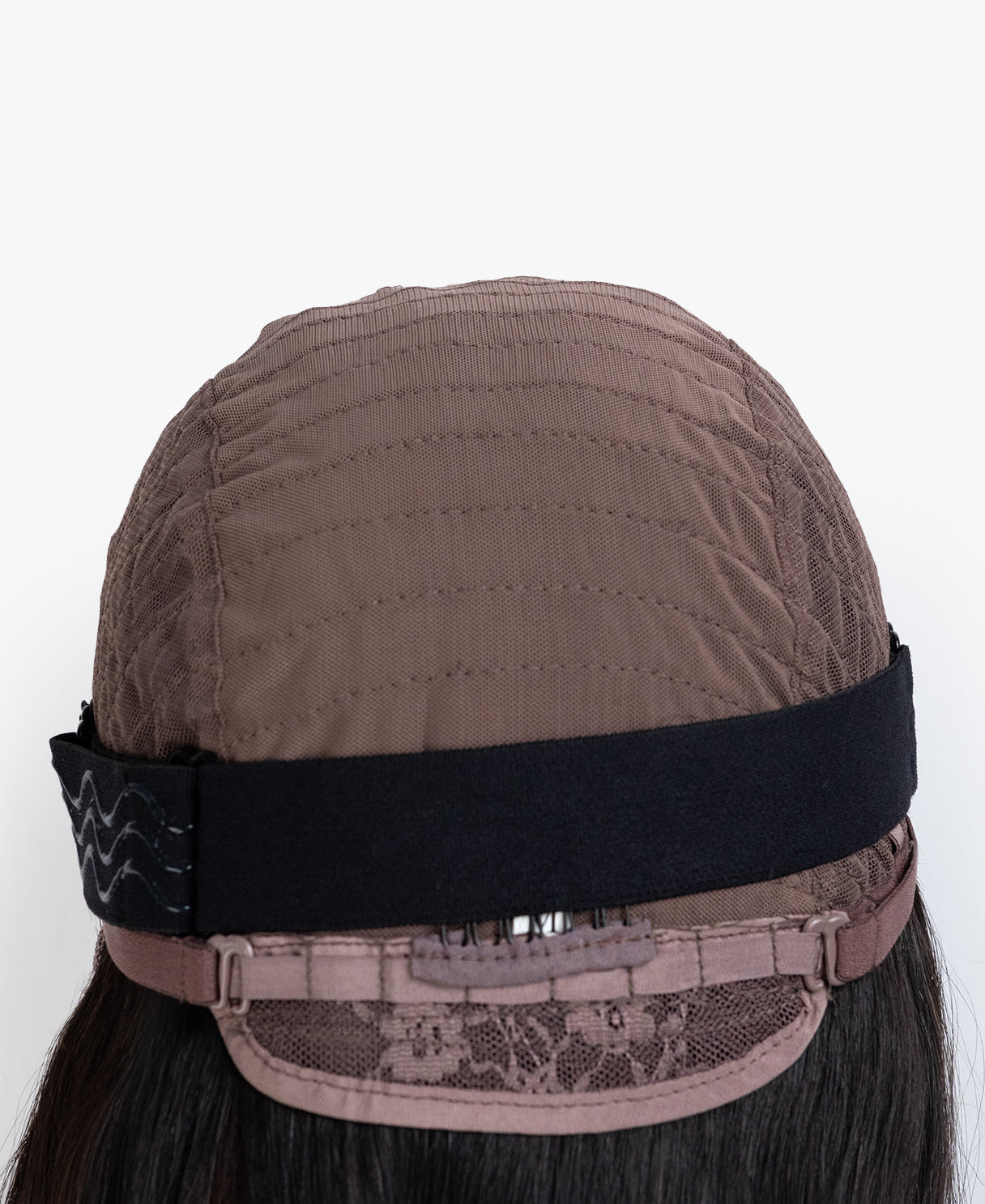Brown wig cap with a black band on a white background