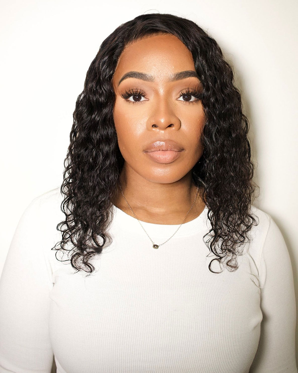 model wearing a black curly human hair wig