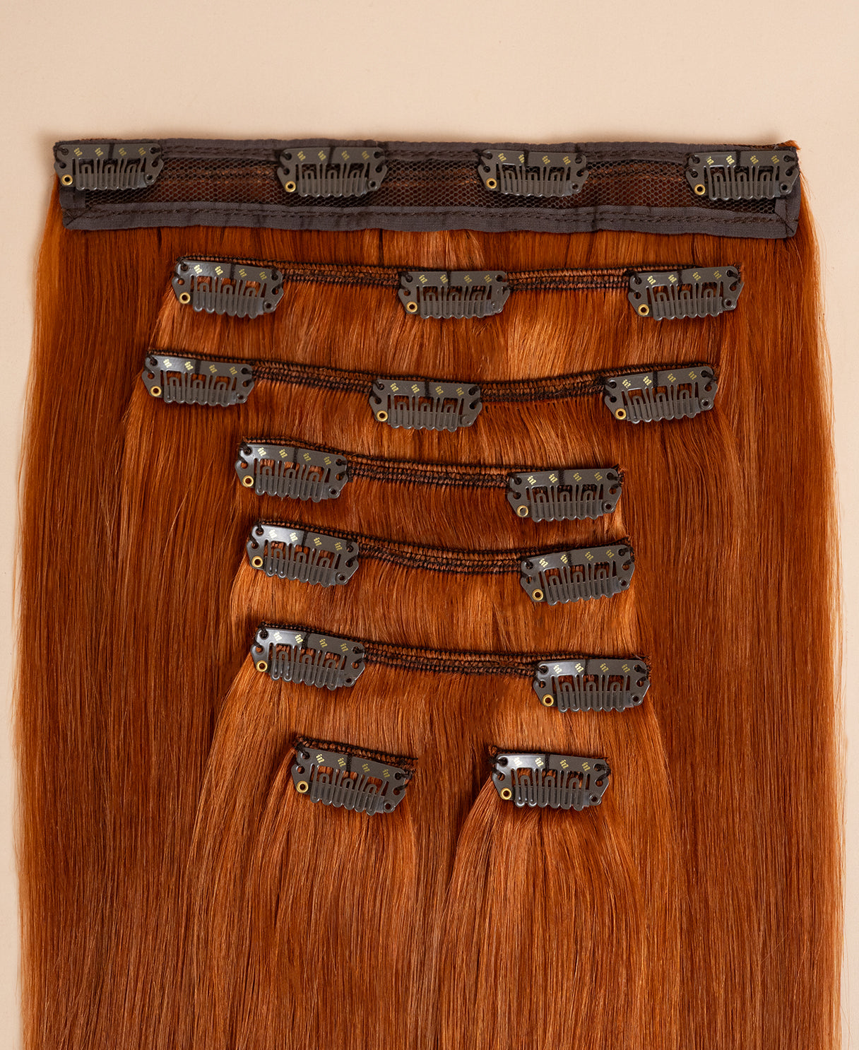 close up of clip in hair extensions in copper wefts