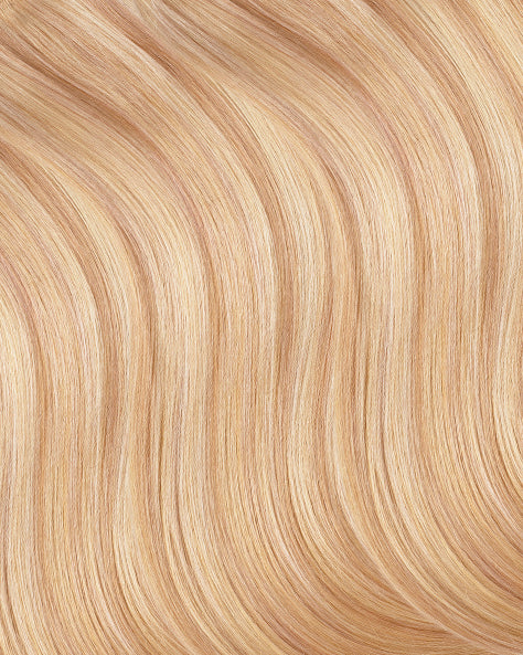 Close-up of blonde hair extensions strands with a wavy texture