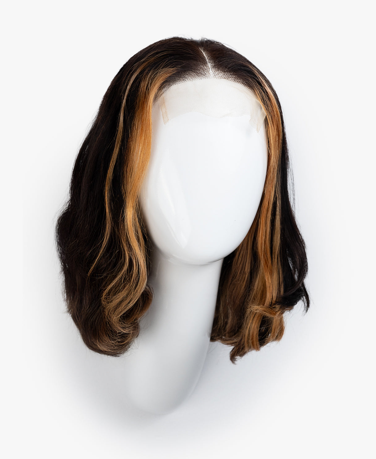 Wig with brown and black color gradient on a mannequin head against a white background