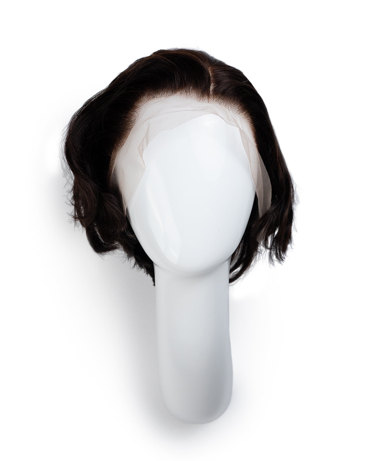 Black wig on a mannequin head against a white background