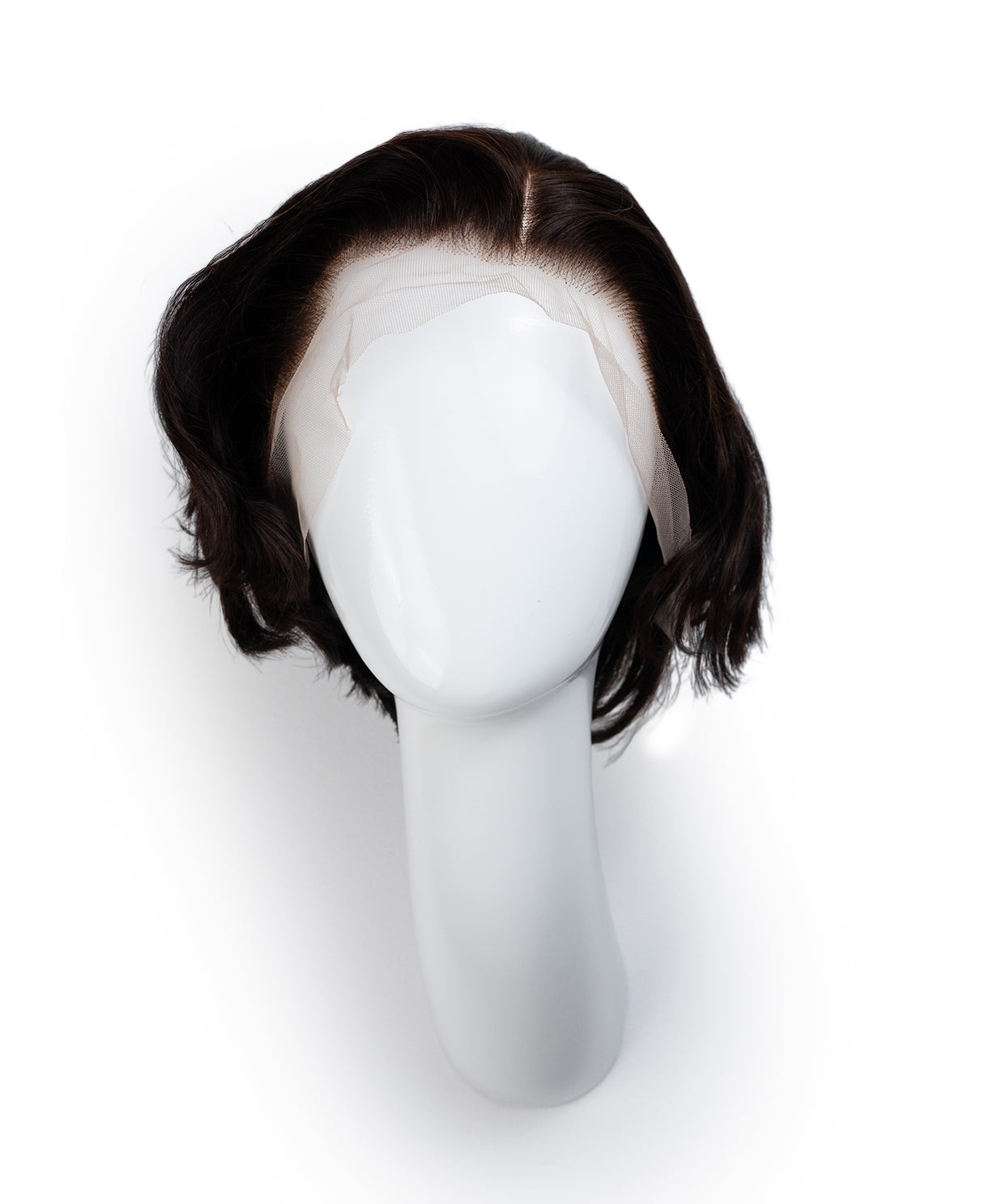 Black wig on a mannequin head against a white background