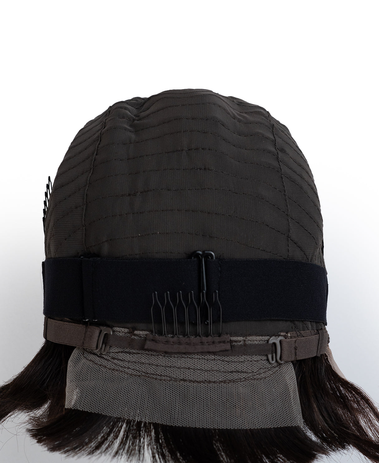 Black wig cap with a comb on a white background