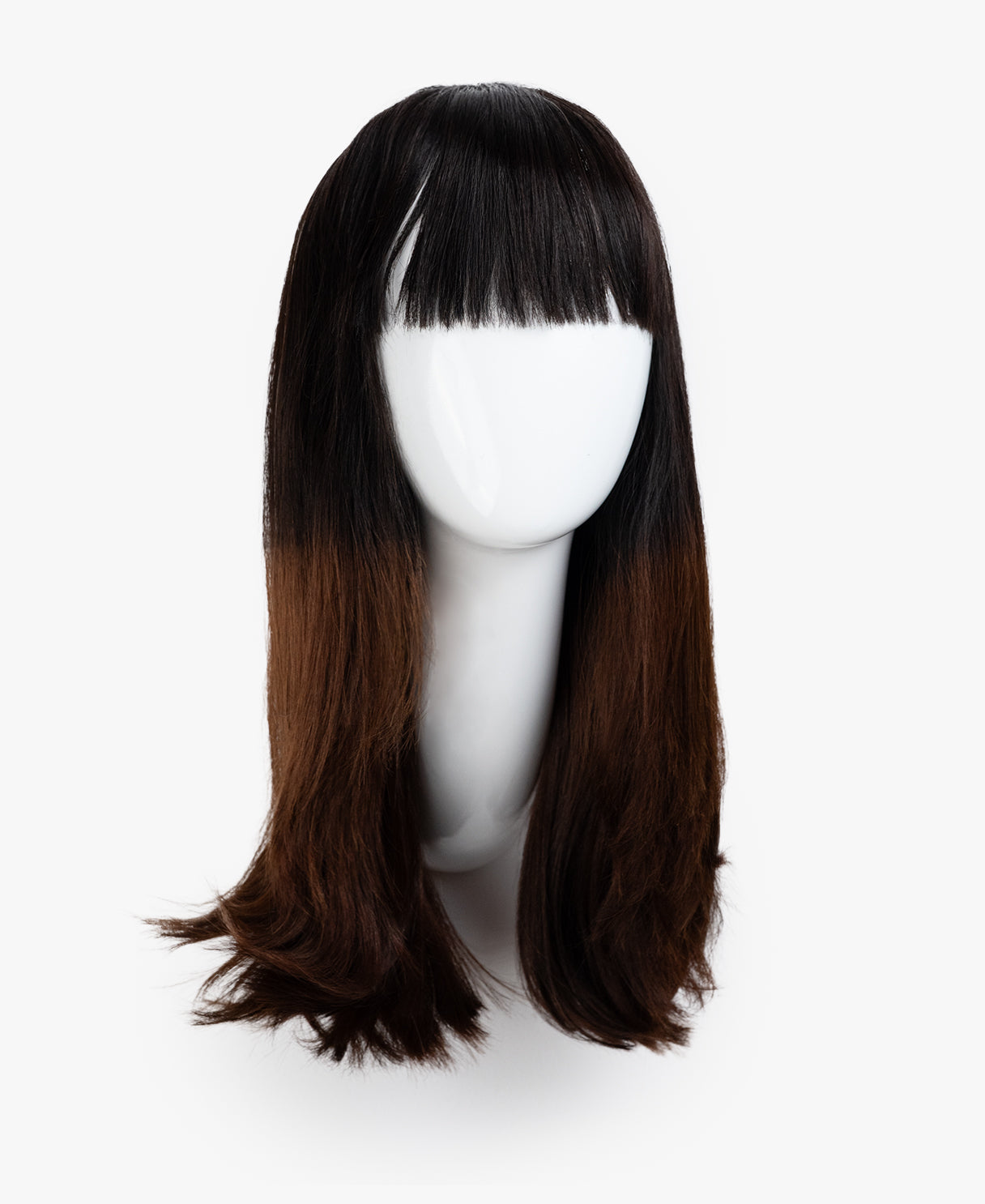 Brown wig with bangs on a white mannequin head against a white background