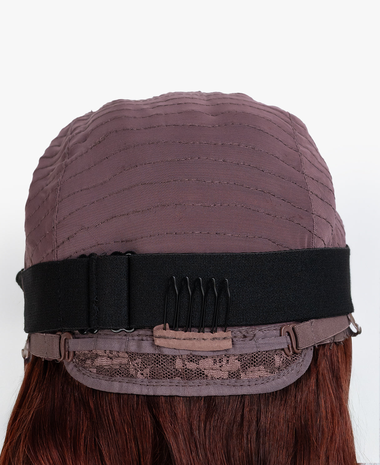 Brown wig cap with a black band on a white background