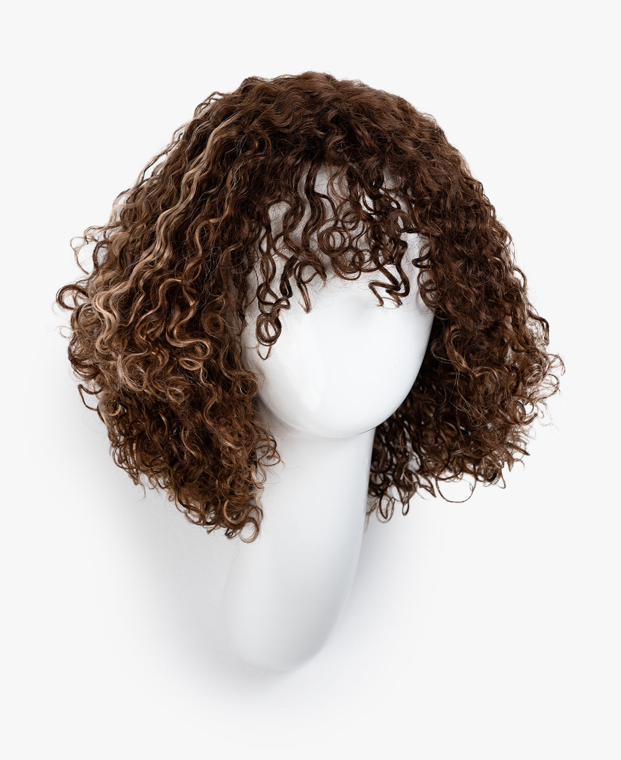 Brown curly wig on a white mannequin head against a white background