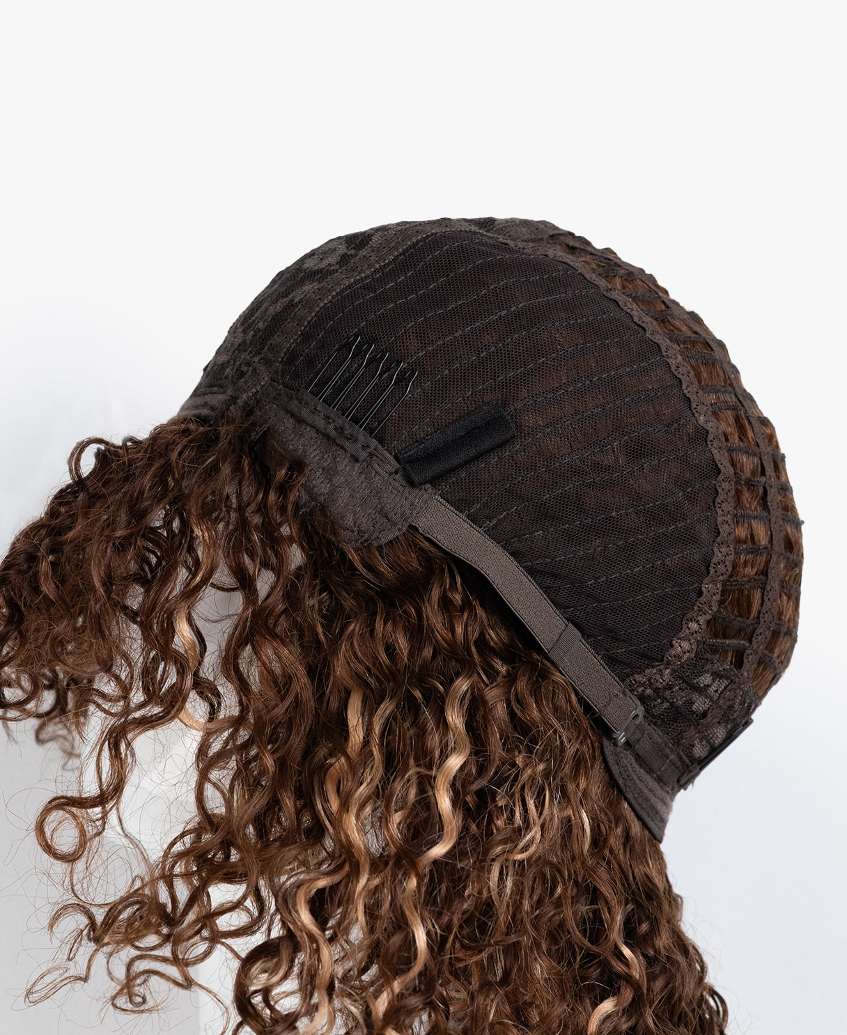 Brown textured cap with curly hair on a white background