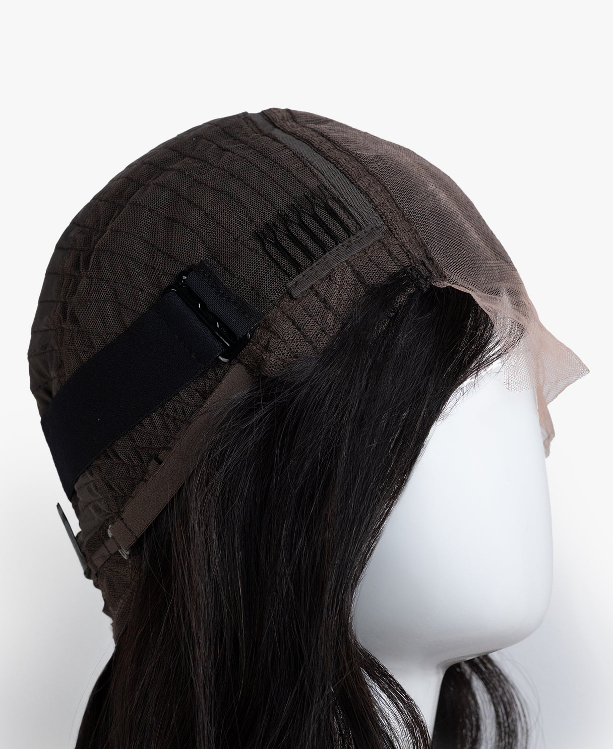 Mannequin head with a brown wig on a white background