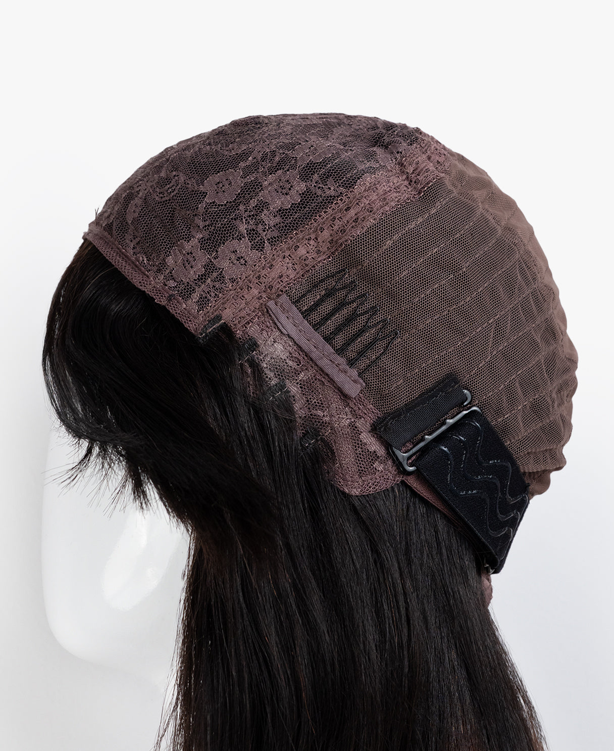 Brown textured wig capw ith a black buckle on a mannequin head against a white background