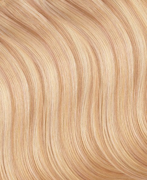 Close-up of blonde hair extensions strands with a wavy texture